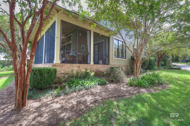 view of front of property with a front lawn and a sunroom