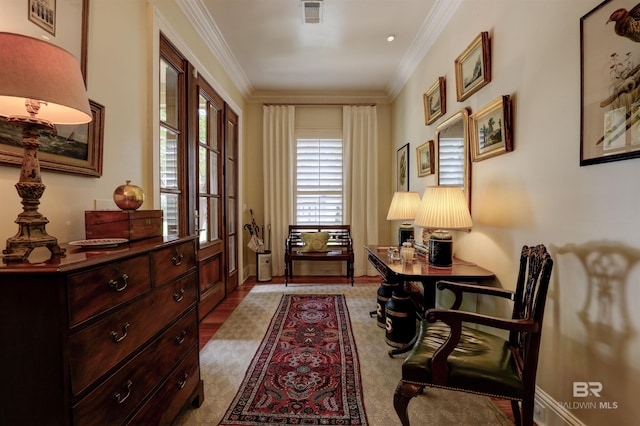 sitting room featuring ornamental molding and light carpet