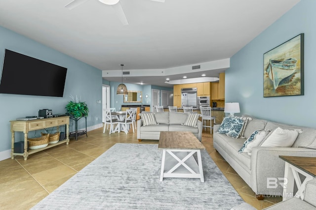 tiled living room with ceiling fan