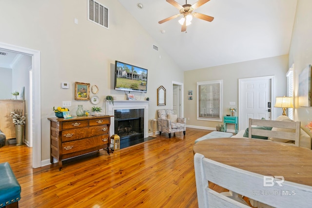 bedroom featuring high vaulted ceiling, wood-type flooring, and ceiling fan