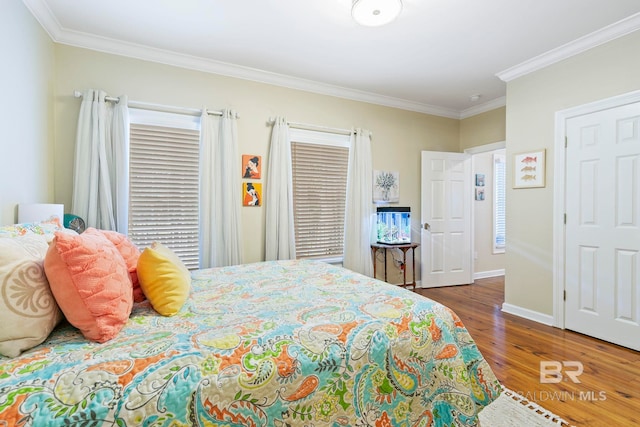 bedroom featuring crown molding and dark hardwood / wood-style flooring