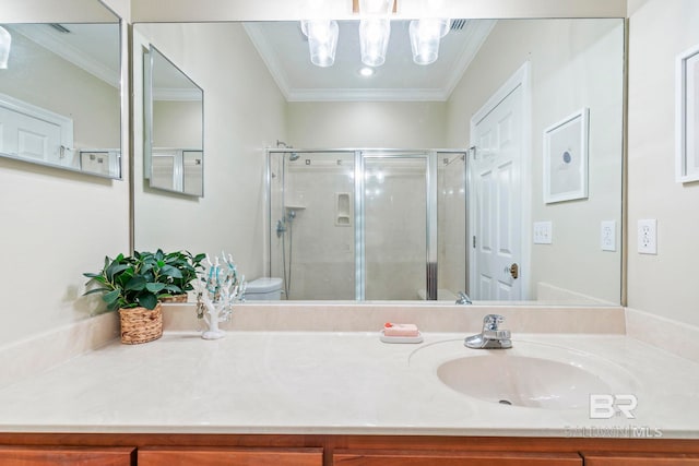 bathroom featuring toilet, a shower with door, and crown molding