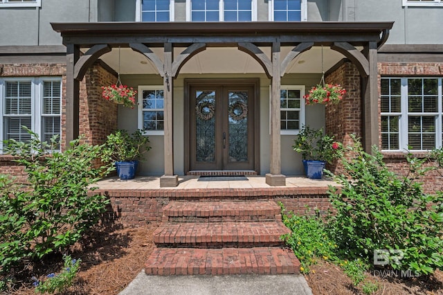 7371 Maureen Cir, Spanish Fort, AL 36527 - property entrance featuring french doors, a porch, brick siding, and stucco siding