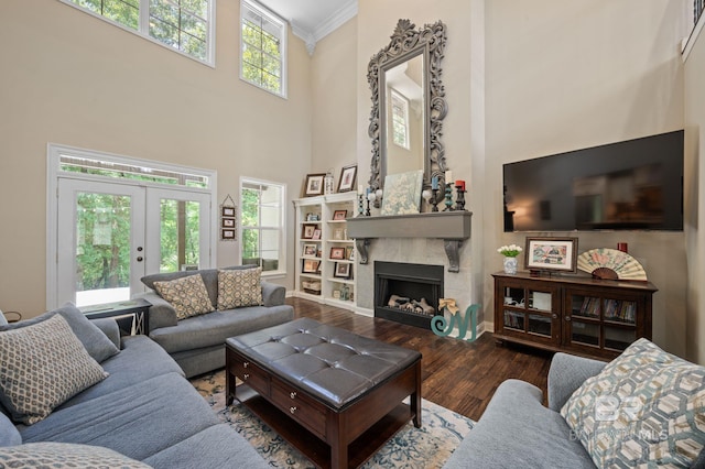7371 Maureen Cir, Spanish Fort, AL 36527 - living area with a high ceiling, wood finished floors, ornamental molding, a fireplace, and french doors