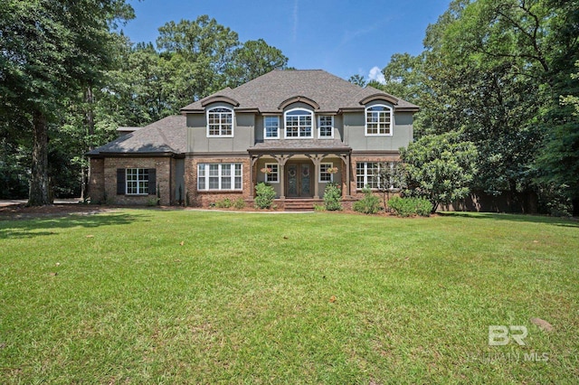 7371 Maureen Cir, Spanish Fort, AL 36527 - french country home featuring a front lawn, stucco siding, and brick siding