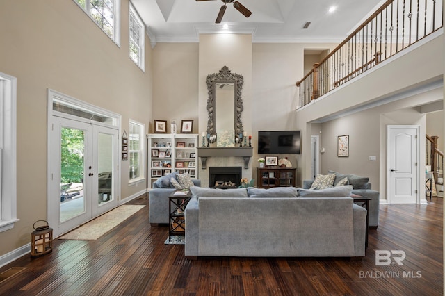 7371 Maureen Cir, Spanish Fort, AL 36527 - living area with a high ceiling, ceiling fan, a fireplace, dark wood-style flooring, and stairs