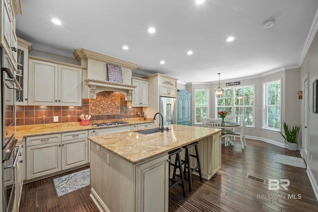 7371 Maureen Cir, Spanish Fort, AL 36527 - kitchen with cream cabinetry, appliances with stainless steel finishes, crown molding, tasteful backsplash, and light stone countertops