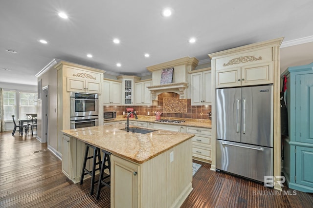 7371 Maureen Cir, Spanish Fort, AL 36527 - kitchen with cream cabinetry, appliances with stainless steel finishes, backsplash, light stone counters, and ornamental molding