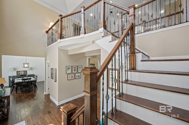 7371 Maureen Cir, Spanish Fort, AL 36527 - stairway featuring a towering ceiling, wood finished floors, and crown molding