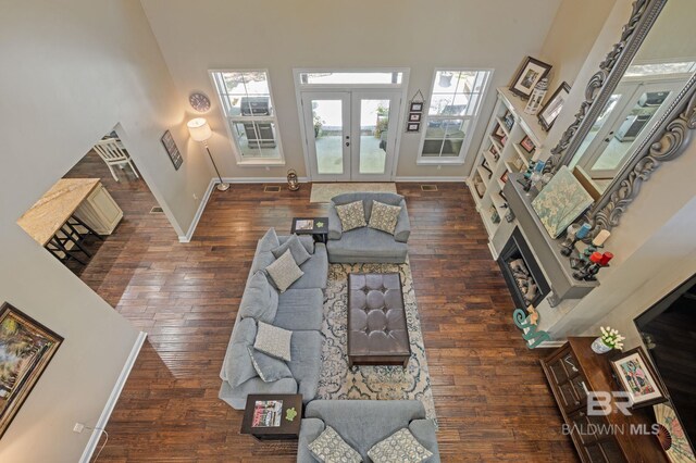 7371 Maureen Cir, Spanish Fort, AL 36527 - living room featuring a high ceiling, wood finished floors, healthy amount of natural light, french doors, and a fireplace