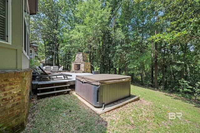 7371 Maureen Cir, Spanish Fort, AL 36527 - view of grassy yard with an outdoor stone fireplace, a hot tub, and a deck
