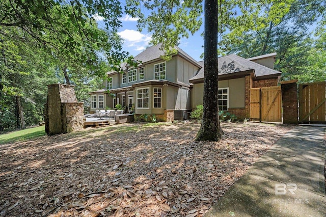 7371 Maureen Cir, Spanish Fort, AL 36527 - view of front of property featuring a gate, a deck, brick siding, a shingled roof, and an outdoor living space