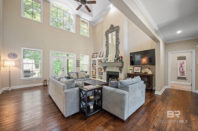 7371 Maureen Cir, Spanish Fort, AL 36527 - living room featuring crown molding, dark wood-type flooring, ceiling fan, plenty of natural light, and a towering ceiling