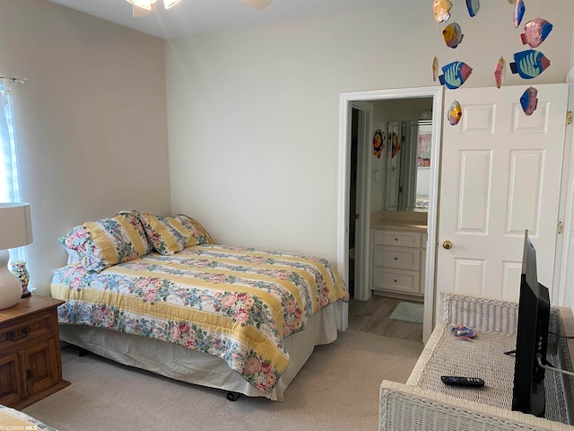 carpeted bedroom with ceiling fan and ensuite bathroom