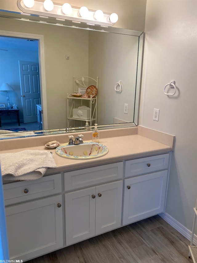 bathroom featuring vanity with extensive cabinet space and wood-type flooring