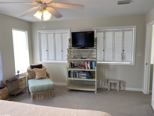 sitting room featuring light carpet and ceiling fan