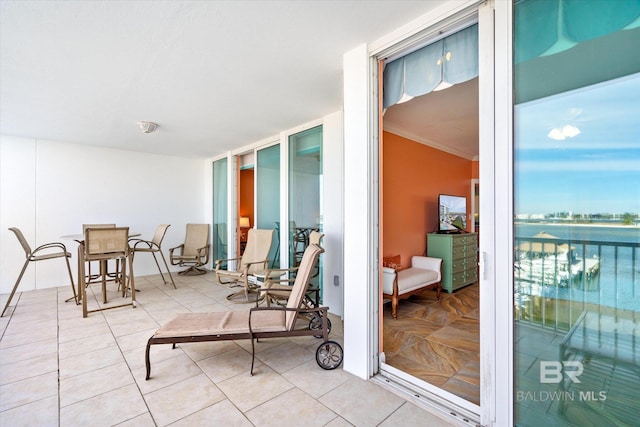 interior space with a water view and a balcony