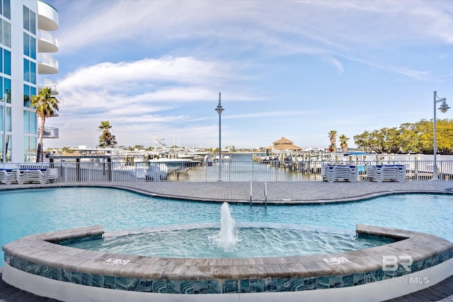 view of swimming pool with pool water feature