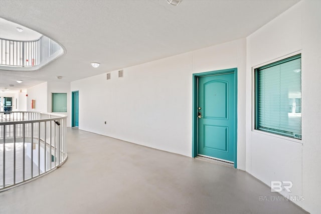 empty room featuring concrete flooring and a textured ceiling