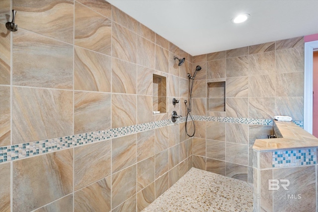 bathroom with a tile shower