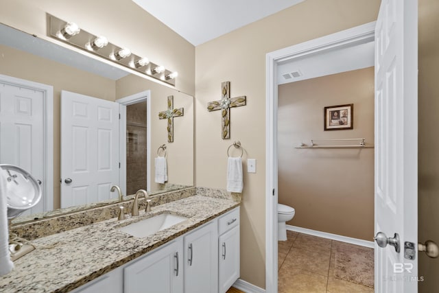 full bathroom featuring tile patterned flooring, toilet, vanity, visible vents, and baseboards