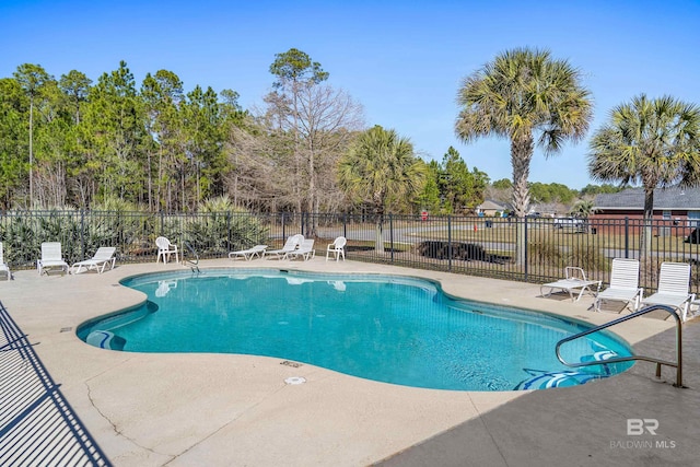 community pool featuring fence and a patio