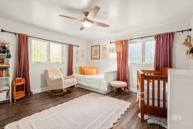 bedroom with a ceiling fan, baseboards, and wood finished floors