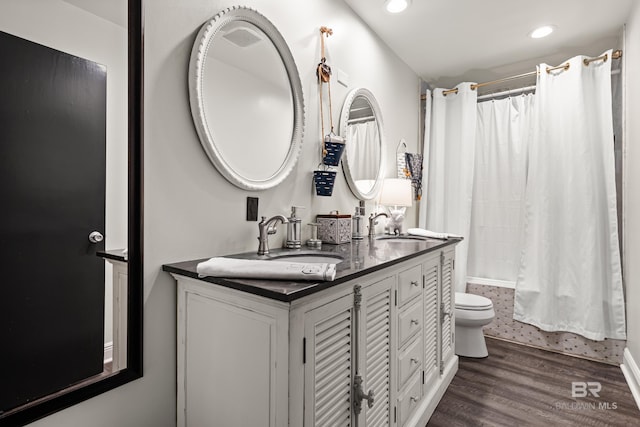 full bathroom with recessed lighting, wood finished floors, shower / bath combo, and a sink