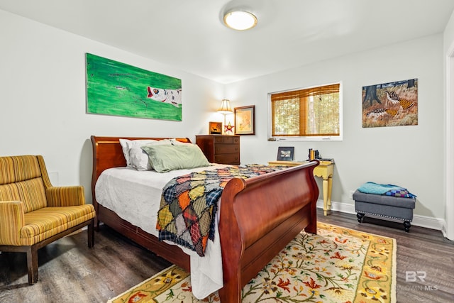 bedroom with baseboards and wood finished floors