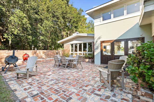 view of patio with outdoor dining space and fence