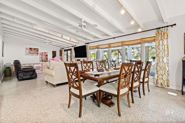 dining space with rail lighting, speckled floor, ceiling fan, and vaulted ceiling with beams