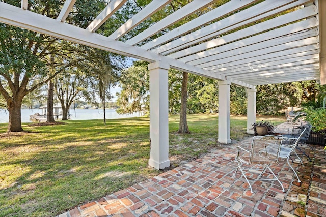 view of patio with a pergola and a water view