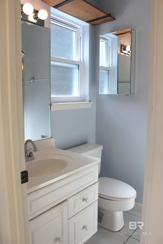 bathroom featuring tile patterned floors, vanity, and toilet