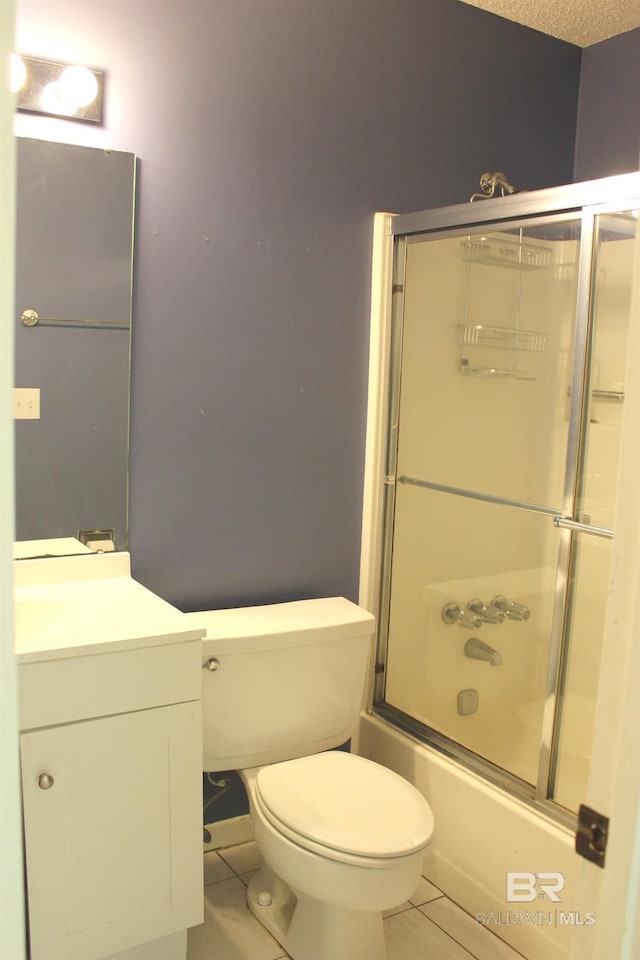 full bathroom with tile patterned floors, a textured ceiling, vanity, enclosed tub / shower combo, and toilet