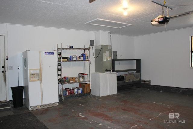 garage with a garage door opener and white fridge with ice dispenser