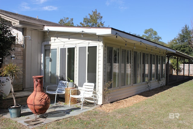 view of home's exterior with a sunroom