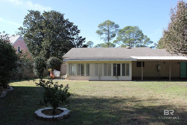 back of property featuring a yard