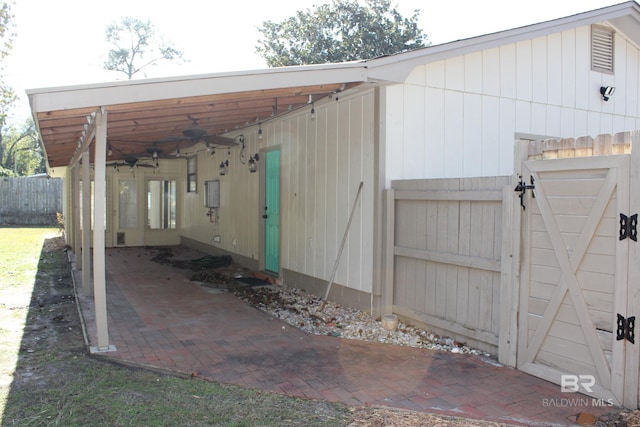 exterior space featuring a carport and ceiling fan