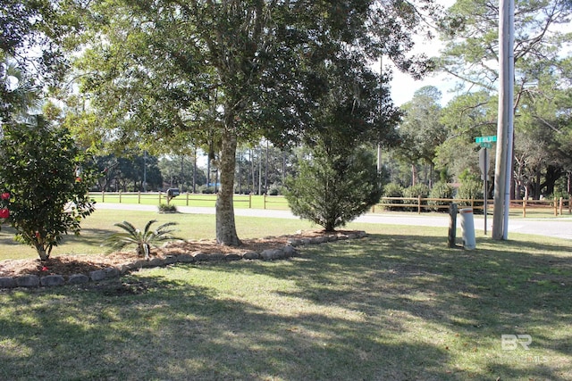 view of property's community with a lawn