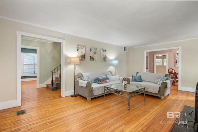 living room with light hardwood / wood-style flooring and a wealth of natural light