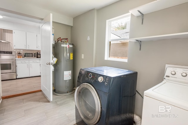 laundry room with electric water heater and washing machine and clothes dryer