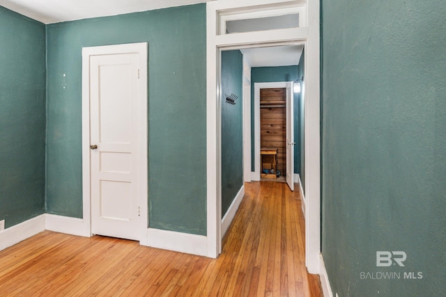 hall with hardwood / wood-style floors