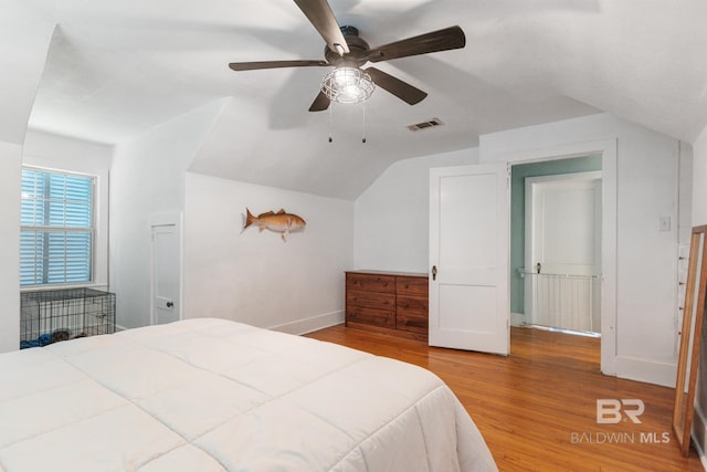 bedroom featuring ceiling fan, wood-type flooring, and vaulted ceiling