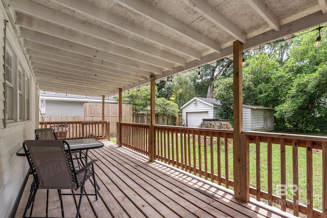 wooden terrace with a yard and an outbuilding