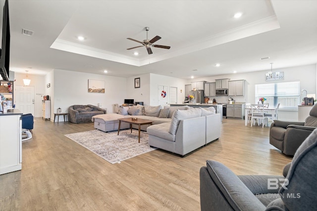 3973 Mercury Cir, Gulf Shores, AL 36542 - living area with a tray ceiling, a ceiling fan, crown molding, light wood finished floors, and recessed lighting