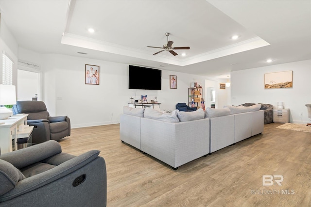 3973 Mercury Cir, Gulf Shores, AL 36542 - living room featuring a raised ceiling, ceiling fan, light wood-style flooring, recessed lighting, and ornamental molding