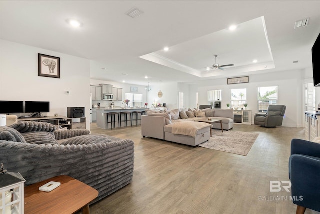 3973 Mercury Cir, Gulf Shores, AL 36542 - living room featuring ceiling fan, a tray ceiling, light wood-style floors, and recessed lighting