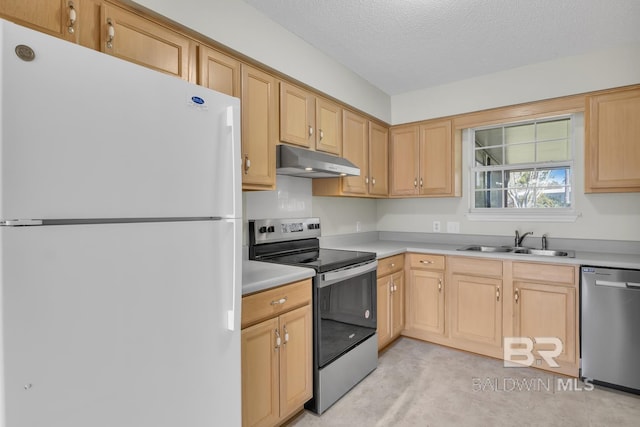 kitchen with under cabinet range hood, light countertops, stainless steel appliances, a textured ceiling, and a sink