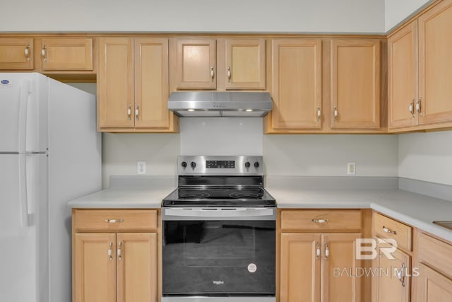 kitchen with light brown cabinets, under cabinet range hood, light countertops, stainless steel range with electric cooktop, and freestanding refrigerator