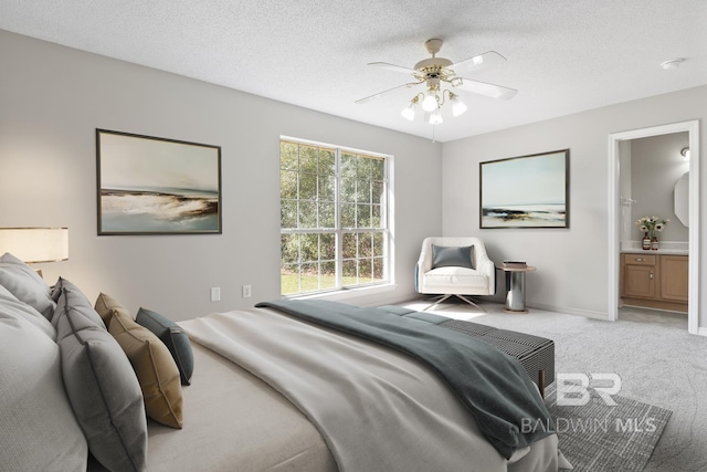 bedroom with baseboards, light carpet, a textured ceiling, and a ceiling fan